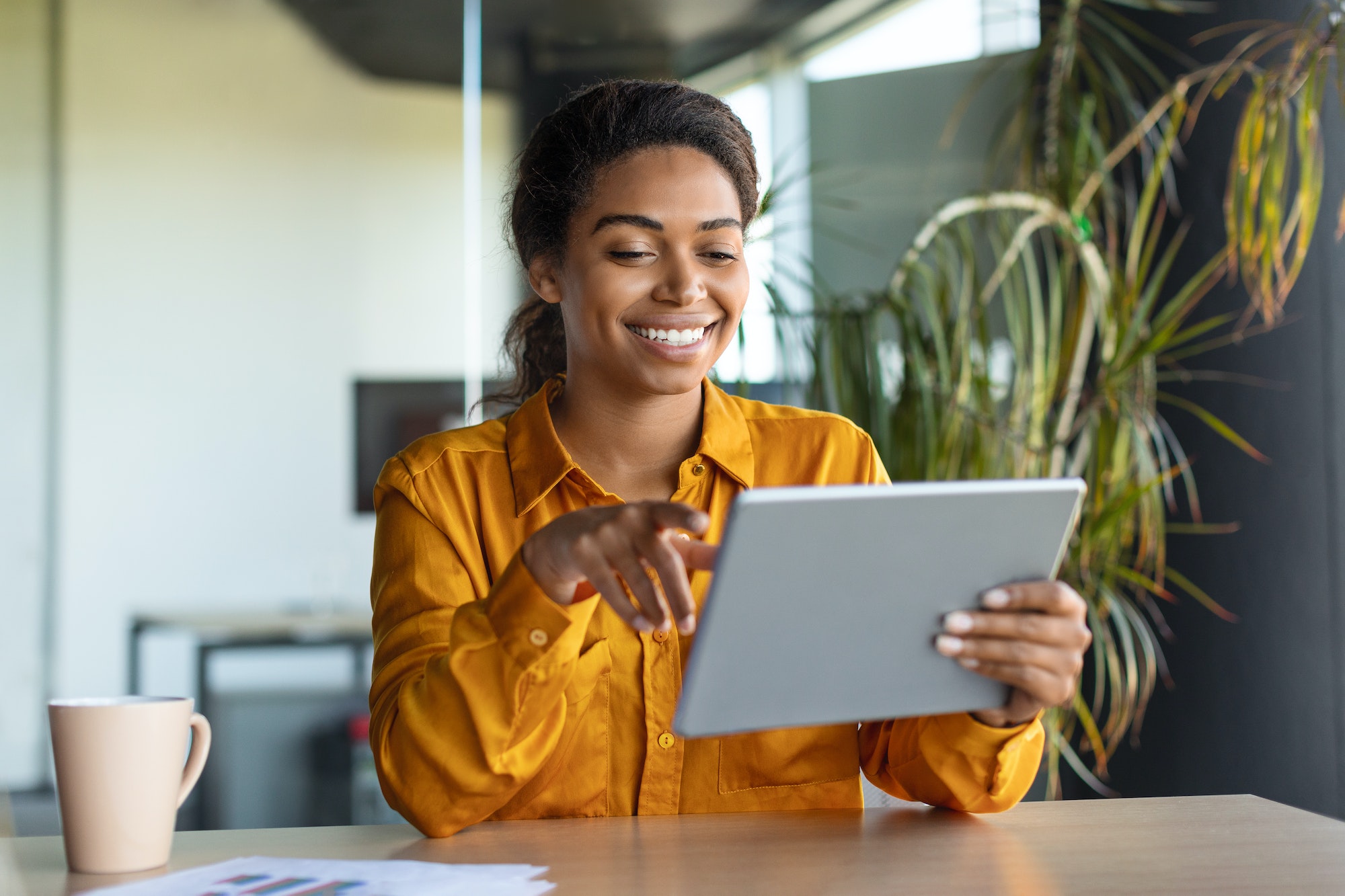 modern-technologies-in-business-happy-black-businesswoman-using-modern-digital-tablet-working.jpg