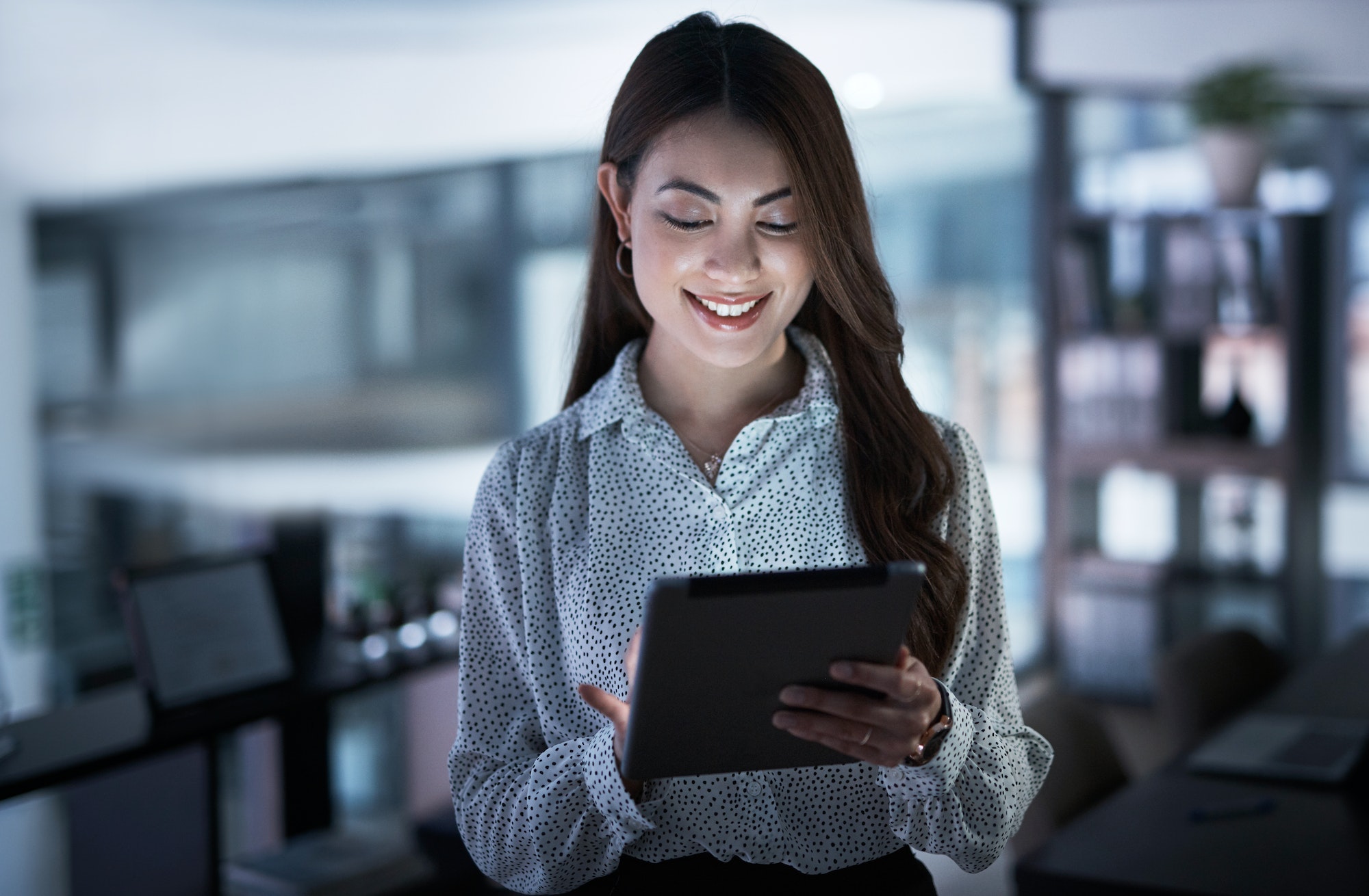 shot-of-a-young-businesswoman-using-a-digital-tablet-in-an-office-at-night.jpg